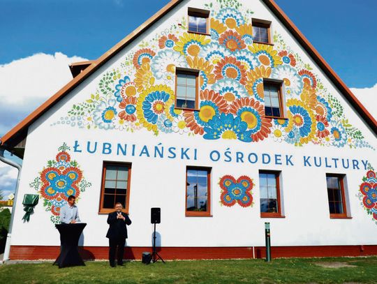 Kolorowy mural inspirowany opolskim wzorem kwiatowym na ścianie domu kultury w Łubnianach