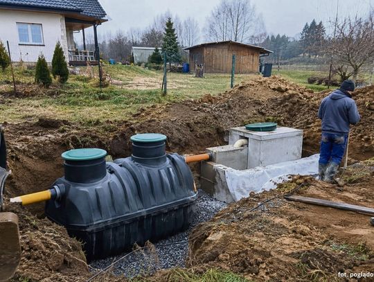 Przydomowa oczyszczalnia ścieków na terenach wiejskich — zbiornik, drenaż i instalacja na działce mieszkańca.